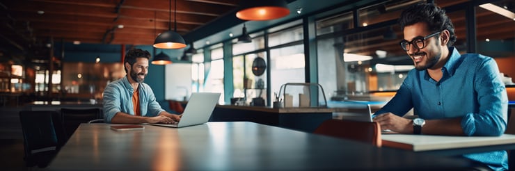 Extreme wide shot, Casual shot, a diverse man happily typing on his laptop alone