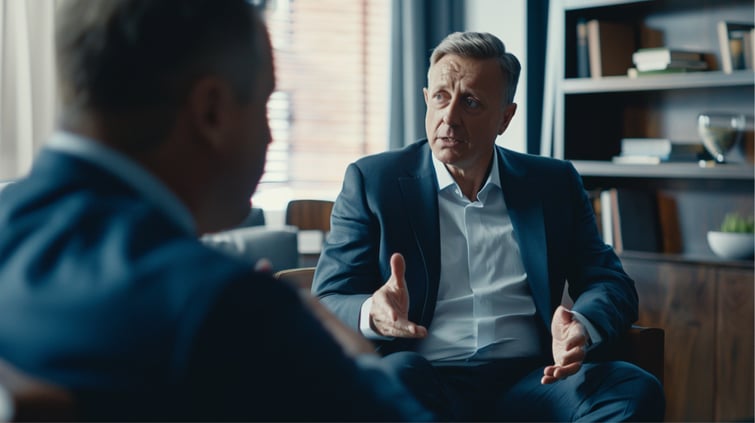 Still shot of speakers in business clothes talking in an online webinar