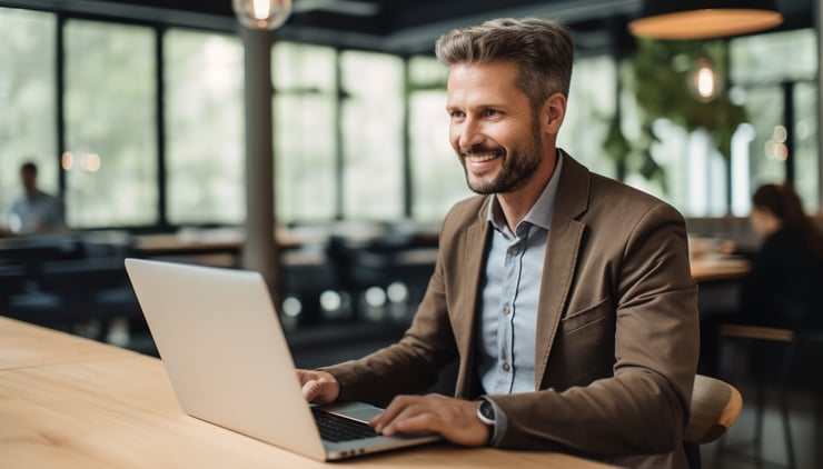 Candid shot of a confident professional man in his late 30s busy working on a laptop